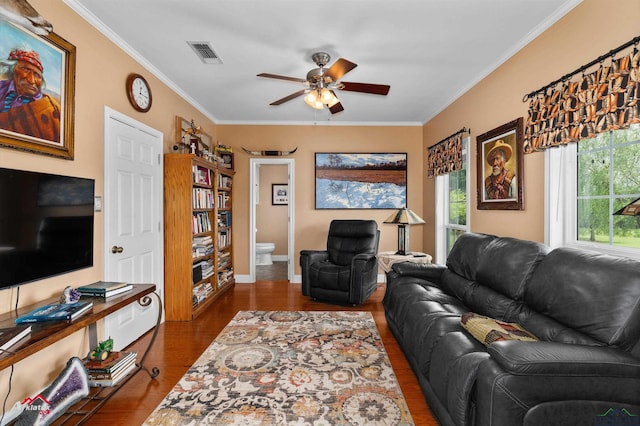 living area featuring crown molding, a ceiling fan, dark wood-style floors, and visible vents