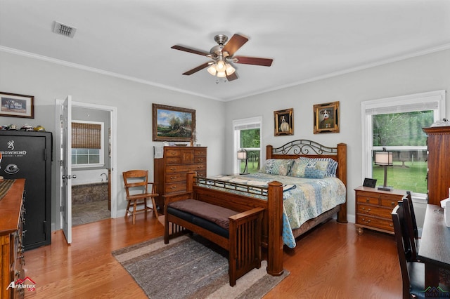 bedroom with visible vents, ornamental molding, and wood finished floors