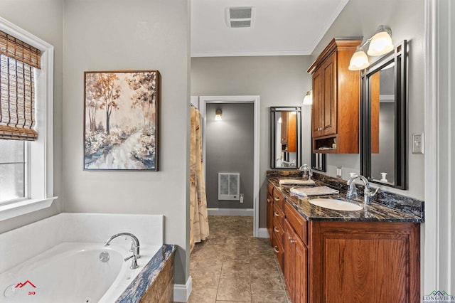 full bathroom with a garden tub, a sink, visible vents, and double vanity