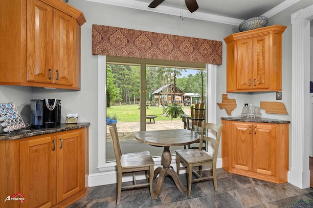 dining space with a healthy amount of sunlight, baseboards, ceiling fan, and ornamental molding