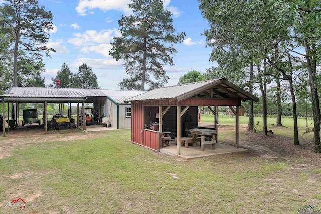exterior space featuring a yard and a detached carport
