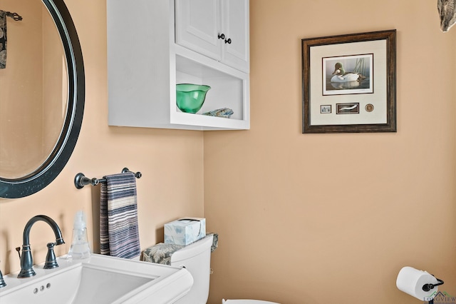 bathroom featuring toilet and a sink