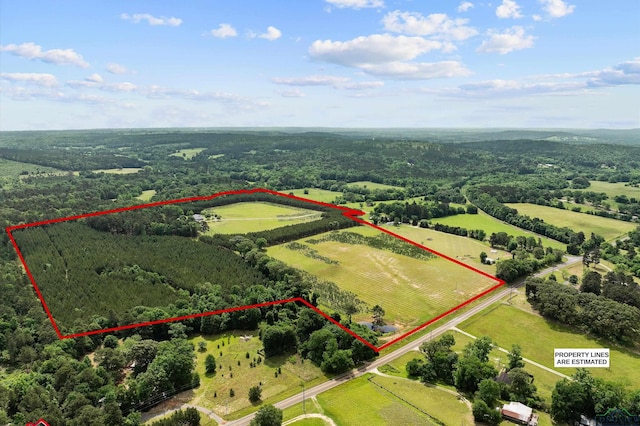 birds eye view of property with a rural view and a wooded view