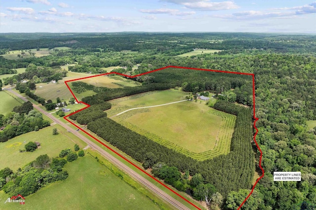 bird's eye view with a wooded view and a rural view