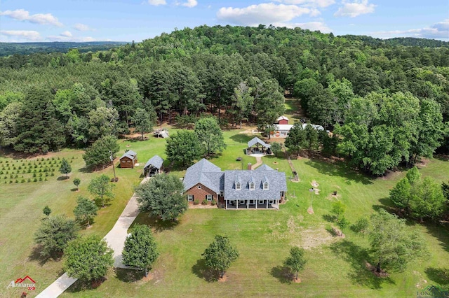 drone / aerial view featuring a forest view