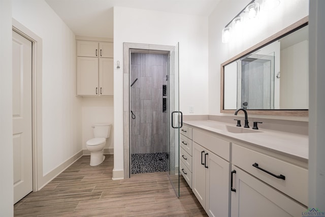 bathroom with vanity, toilet, and walk in shower