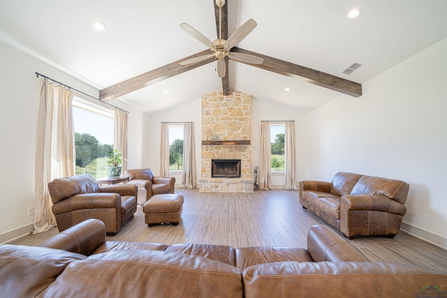 living room featuring lofted ceiling with beams, ceiling fan, a fireplace, and light hardwood / wood-style floors