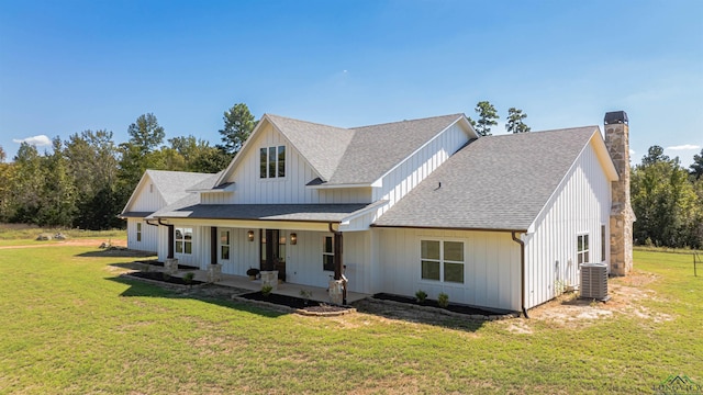 modern farmhouse with central AC, a front lawn, and covered porch