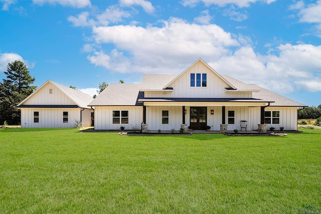 back of house featuring a yard and covered porch