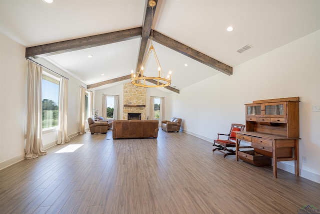 living room with hardwood / wood-style floors, vaulted ceiling with beams, a fireplace, and a chandelier