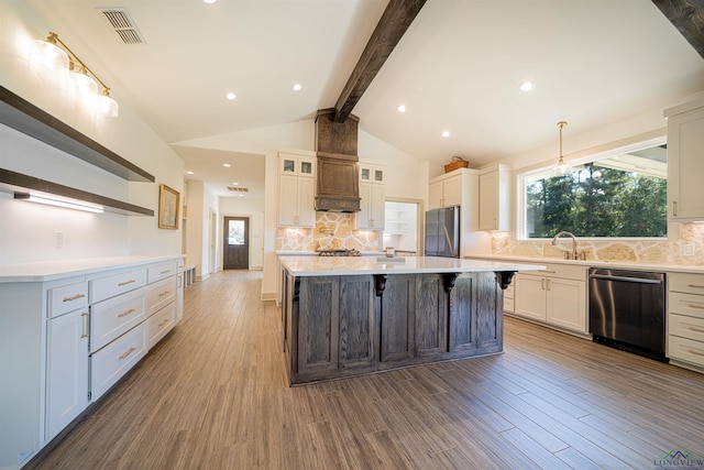 kitchen with white cabinetry, decorative backsplash, a large island, and stainless steel appliances