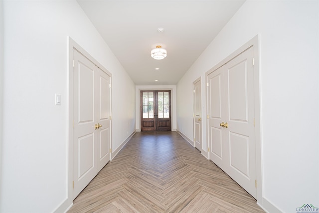 doorway with french doors and light parquet flooring