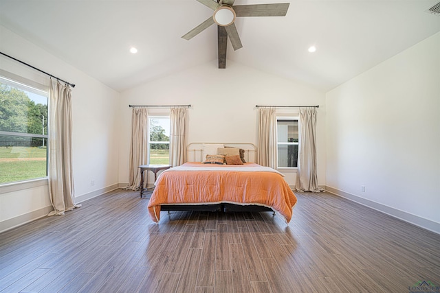 bedroom featuring hardwood / wood-style flooring, ceiling fan, lofted ceiling with beams, and multiple windows