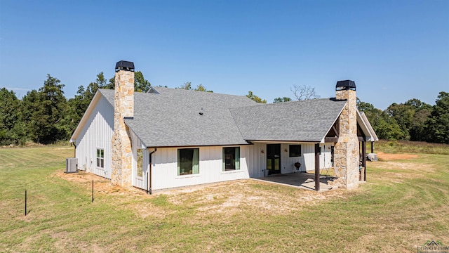 back of property featuring central AC, a patio area, and a lawn