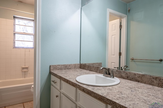 full bathroom featuring tile patterned flooring, vanity, tiled shower / bath combo, and toilet