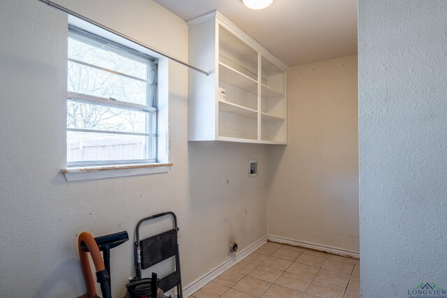 washroom with hookup for a washing machine, hookup for an electric dryer, and light tile patterned floors