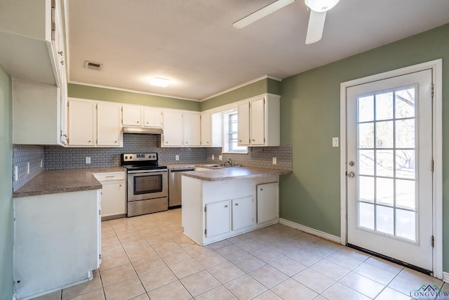 kitchen featuring light tile patterned flooring, appliances with stainless steel finishes, white cabinetry, backsplash, and ceiling fan