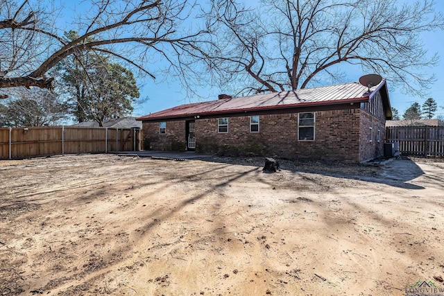 rear view of house featuring central AC unit