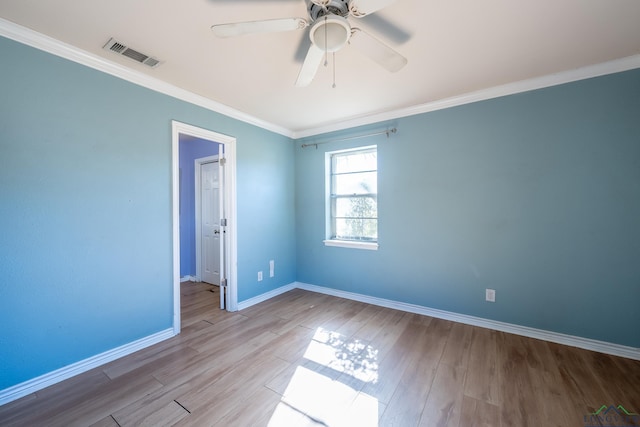 spare room with crown molding, ceiling fan, and light hardwood / wood-style flooring