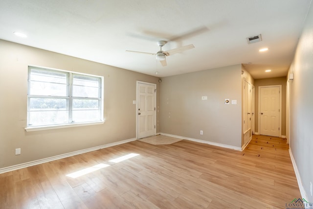 spare room featuring ceiling fan and light hardwood / wood-style flooring