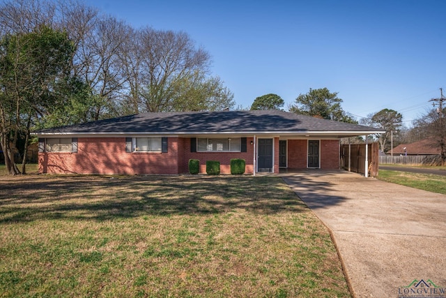 single story home with a front lawn, driveway, a carport, fence, and brick siding