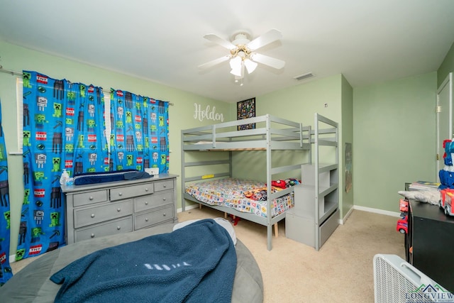 carpeted bedroom with baseboards, visible vents, and ceiling fan