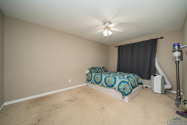 carpeted bedroom with baseboards and a ceiling fan