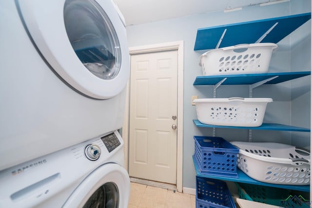 laundry area with tile patterned flooring, laundry area, and stacked washer and dryer