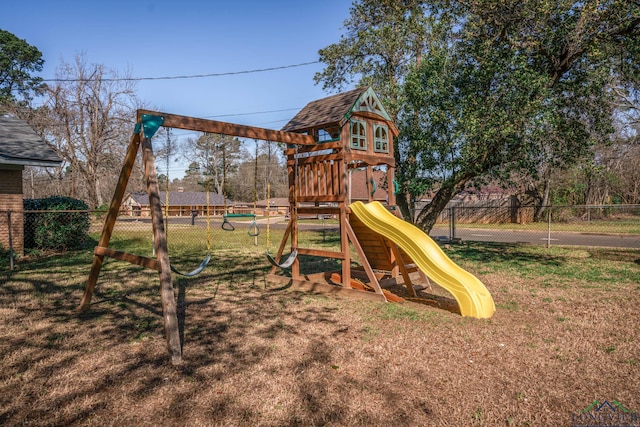 view of jungle gym with a yard and fence