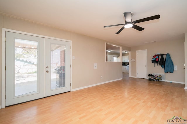 unfurnished living room with light wood finished floors, french doors, baseboards, and ceiling fan