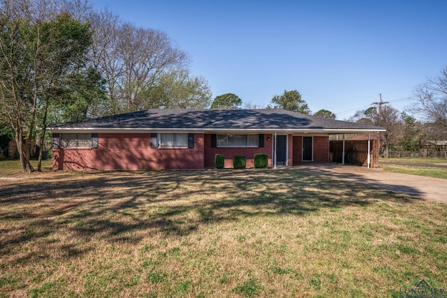 ranch-style home with a carport, concrete driveway, a front yard, and brick siding