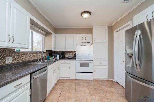 kitchen featuring under cabinet range hood, a sink, backsplash, white cabinetry, and stainless steel appliances