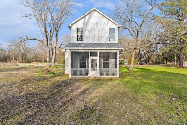 view of front facade featuring a sunroom and a front lawn