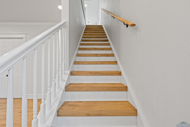 stairs featuring hardwood / wood-style floors