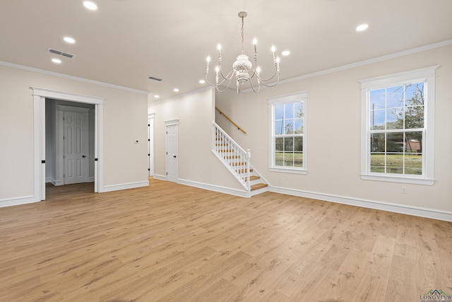 unfurnished living room featuring crown molding, an inviting chandelier, and light hardwood / wood-style floors