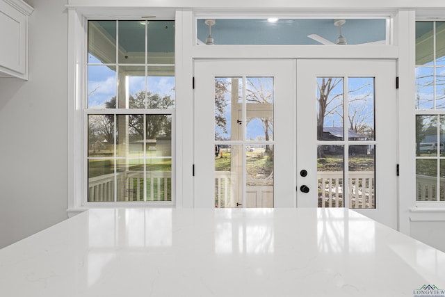 entryway with ceiling fan and french doors