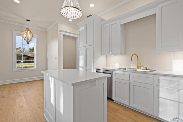 kitchen featuring dishwasher, white cabinetry, sink, crown molding, and light hardwood / wood-style flooring