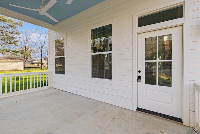 doorway to property with ceiling fan and a patio