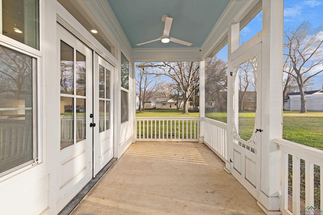 unfurnished sunroom featuring ceiling fan