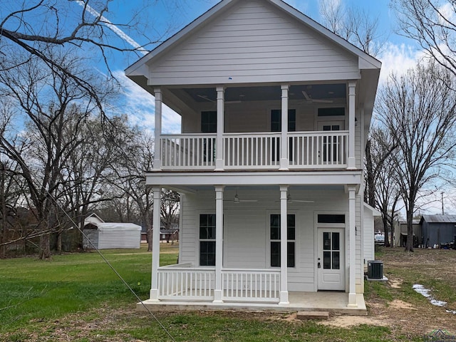 view of front of home featuring a balcony, a porch, cooling unit, and a front yard