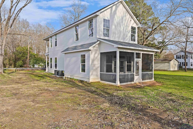 view of property exterior featuring central AC unit, a lawn, and a sunroom