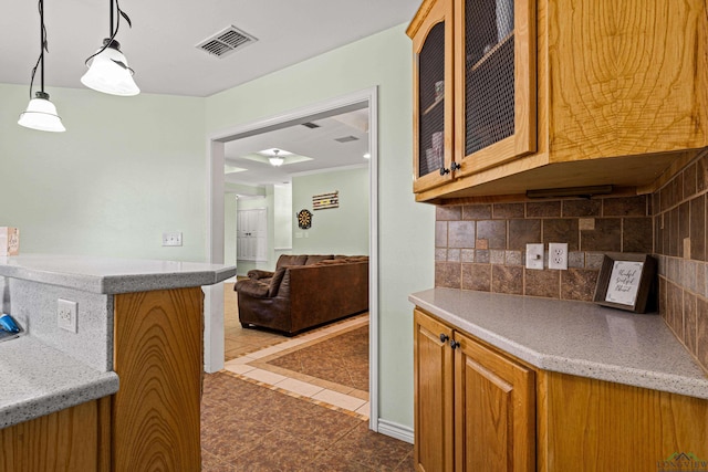 kitchen featuring pendant lighting, dark tile patterned floors, and backsplash