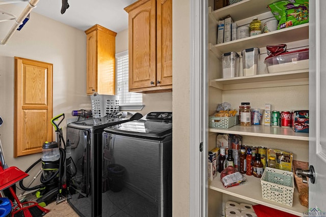 laundry room with cabinets and washer and clothes dryer