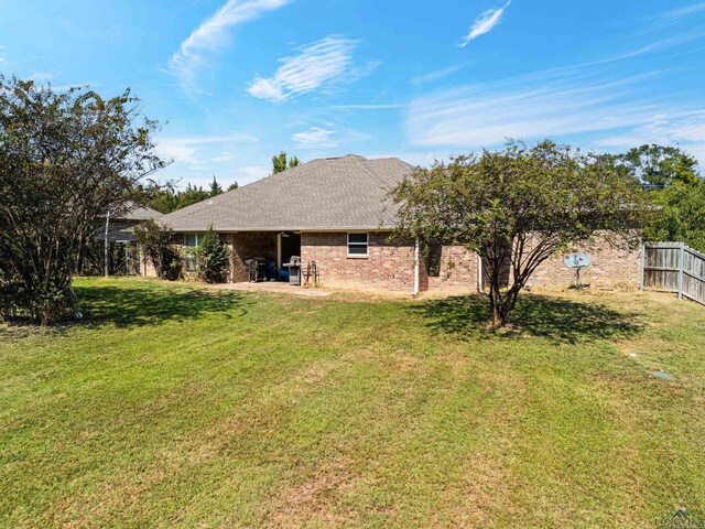 back of property featuring a lawn