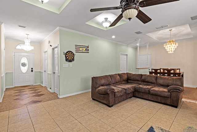 living room featuring crown molding, ceiling fan with notable chandelier, light tile patterned floors, and a tray ceiling