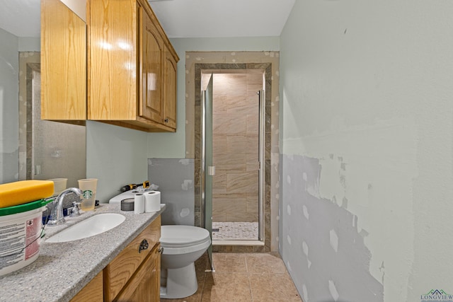 bathroom with vanity, an enclosed shower, tile patterned flooring, and toilet