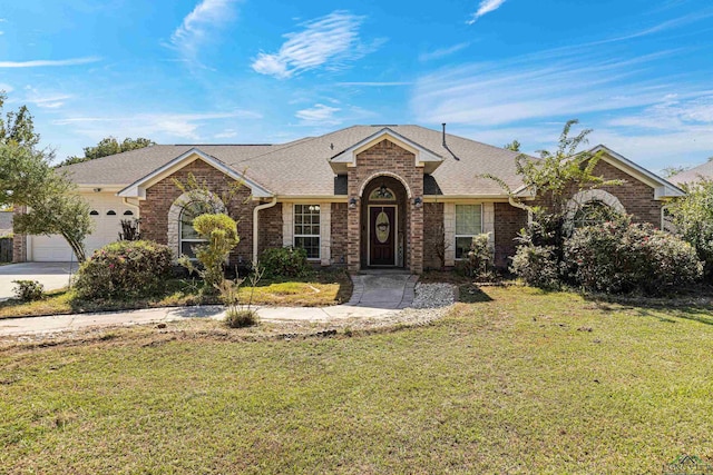 single story home featuring a garage and a front lawn