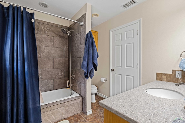 full bathroom featuring shower / tub combo with curtain, vanity, toilet, and tile patterned floors