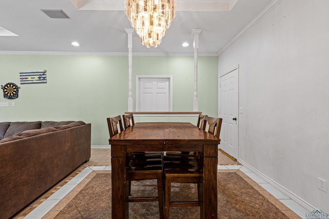 tiled dining room featuring ornamental molding, a chandelier, and decorative columns