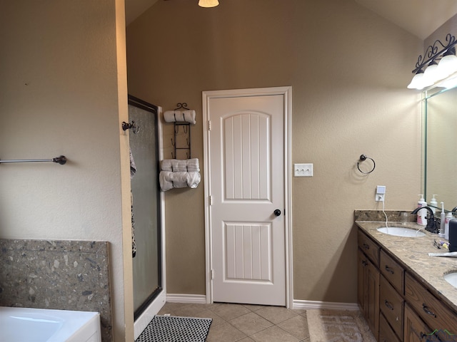 bathroom with tile patterned floors, a sink, a shower stall, a bath, and vaulted ceiling